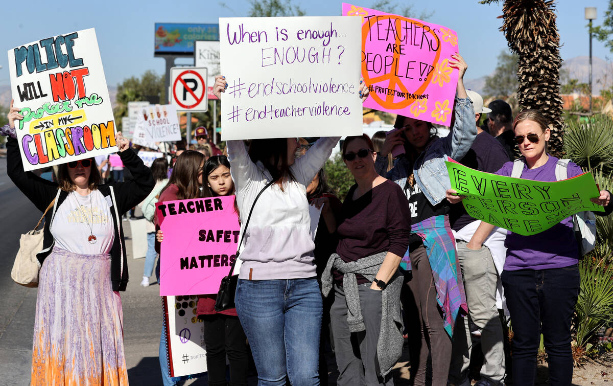 Parents, teachers and students protest violence in schools during a demonstration outside Clark ...