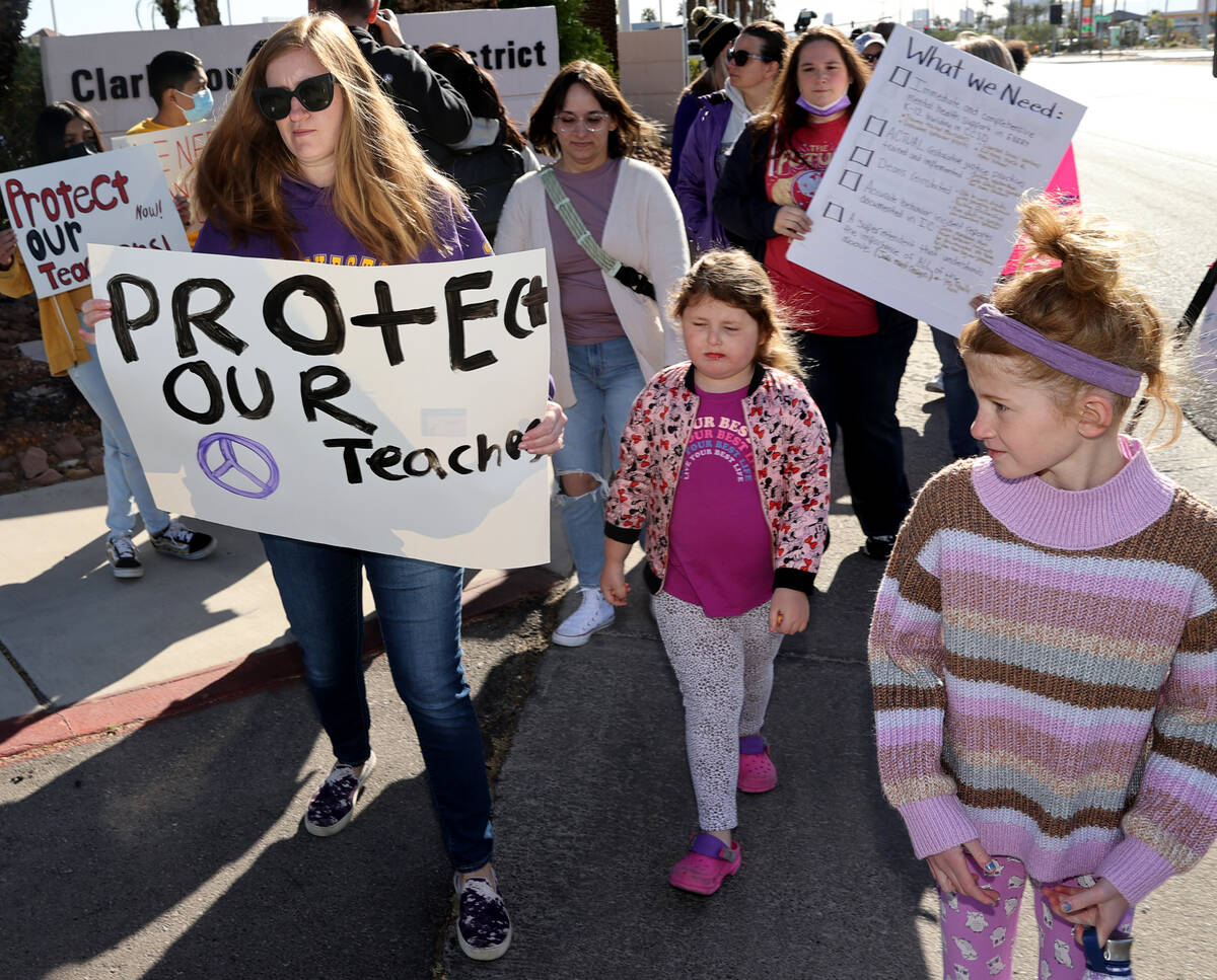 Erin Dressler, left, and her daughters Natalie, 5, and Allison, 9, protest school violence in s ...