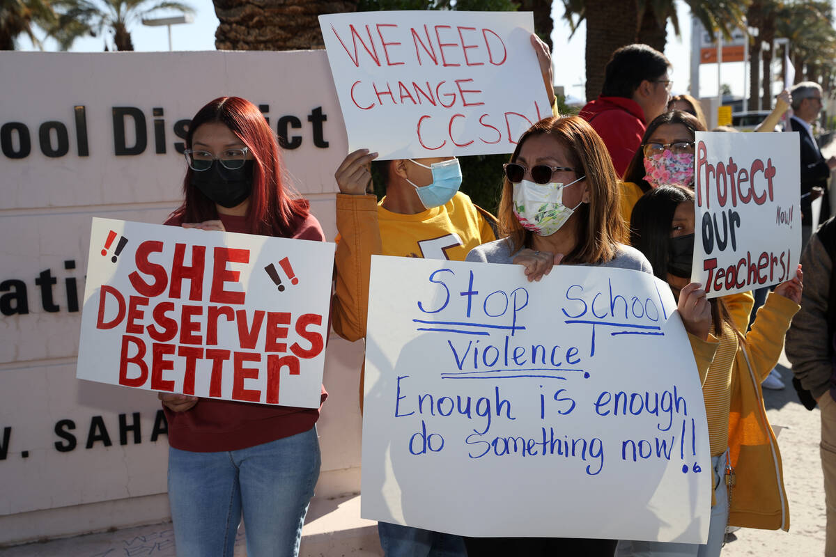 Andrea S., center, an educator who decline to give her last name, protests school violence with ...