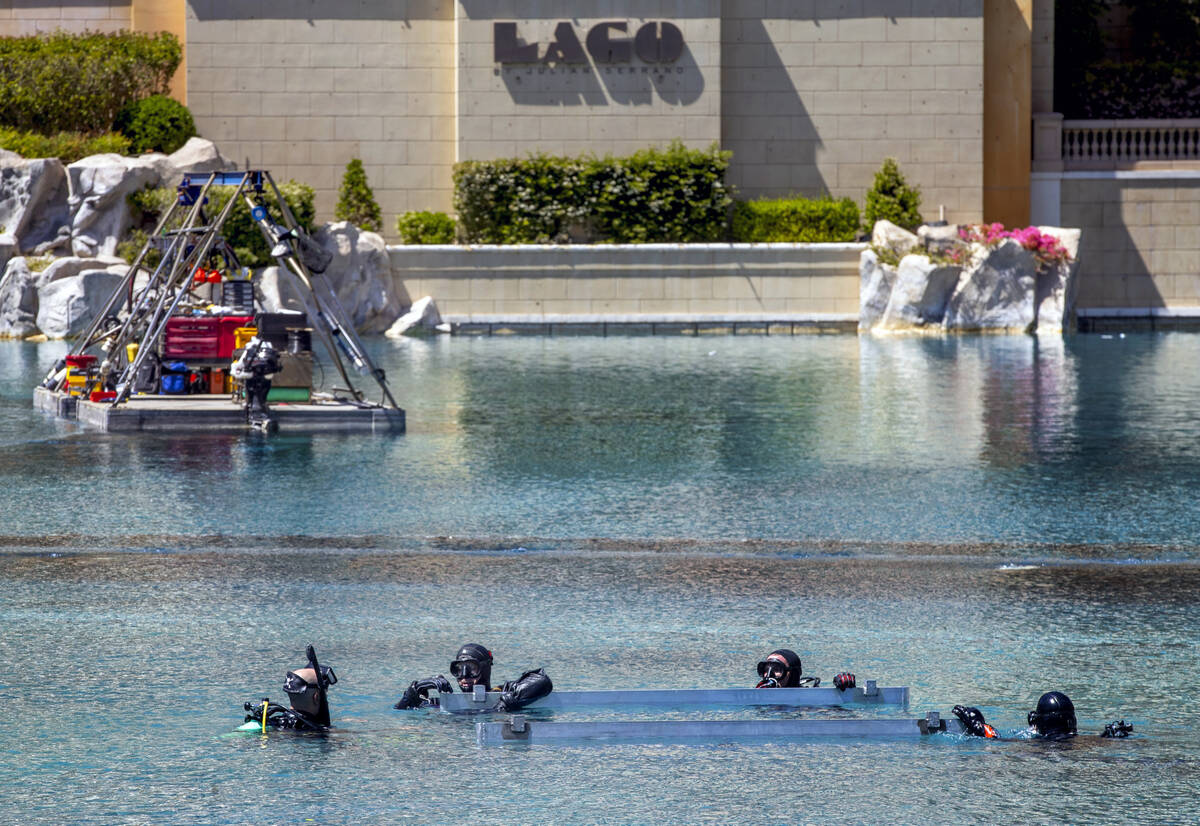 Divers secure metal braces within the water about the Bellagio Fountains as construction has st ...