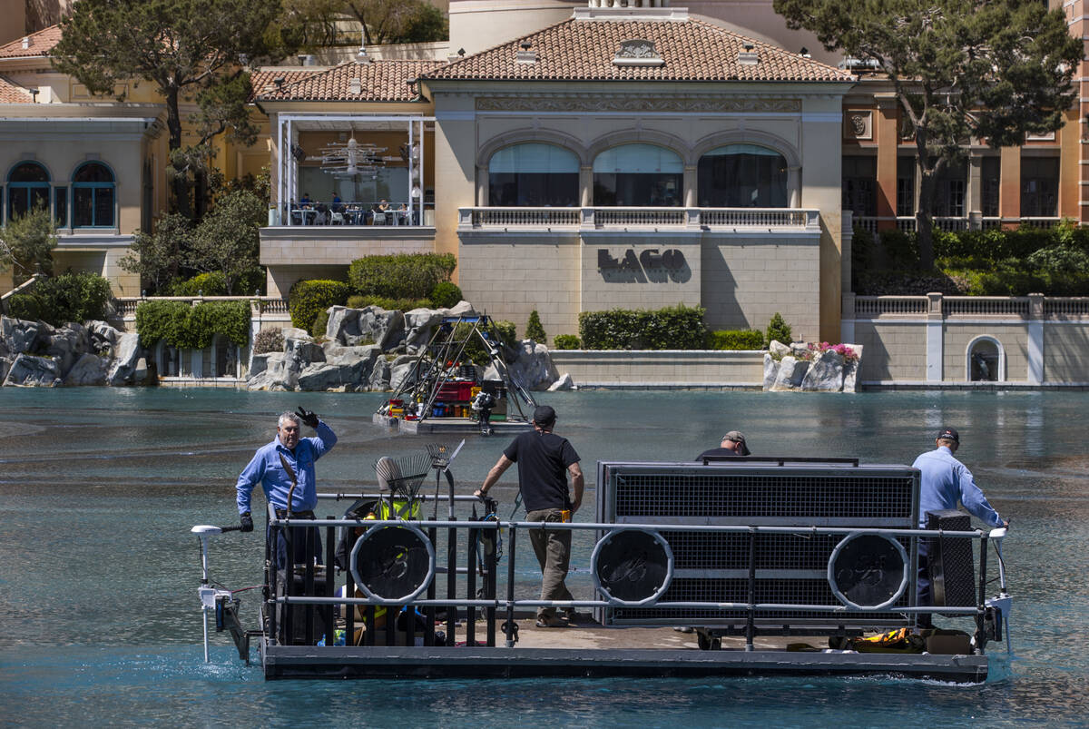 A boat crew cruises about the Bellagio Fountains as construction has started on the NFL red car ...