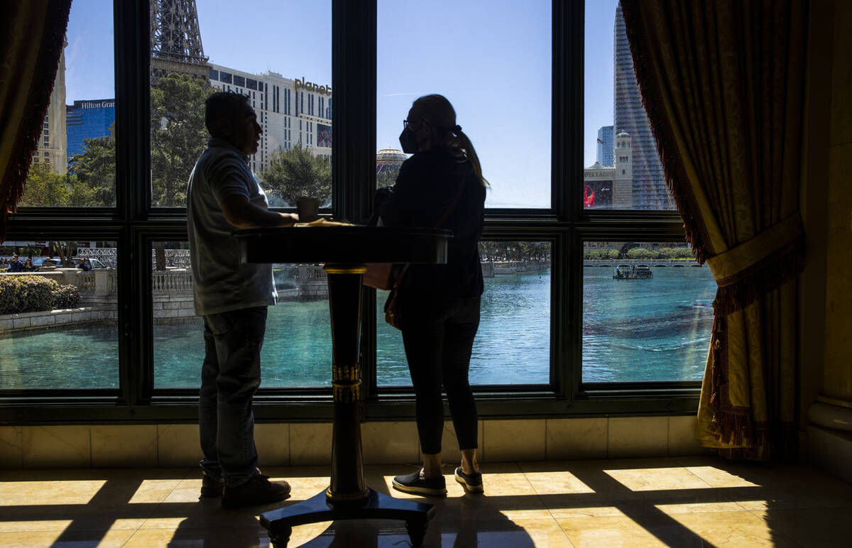 Visitors watch as divers and small boats take to the Bellagio Fountains as construction has sta ...