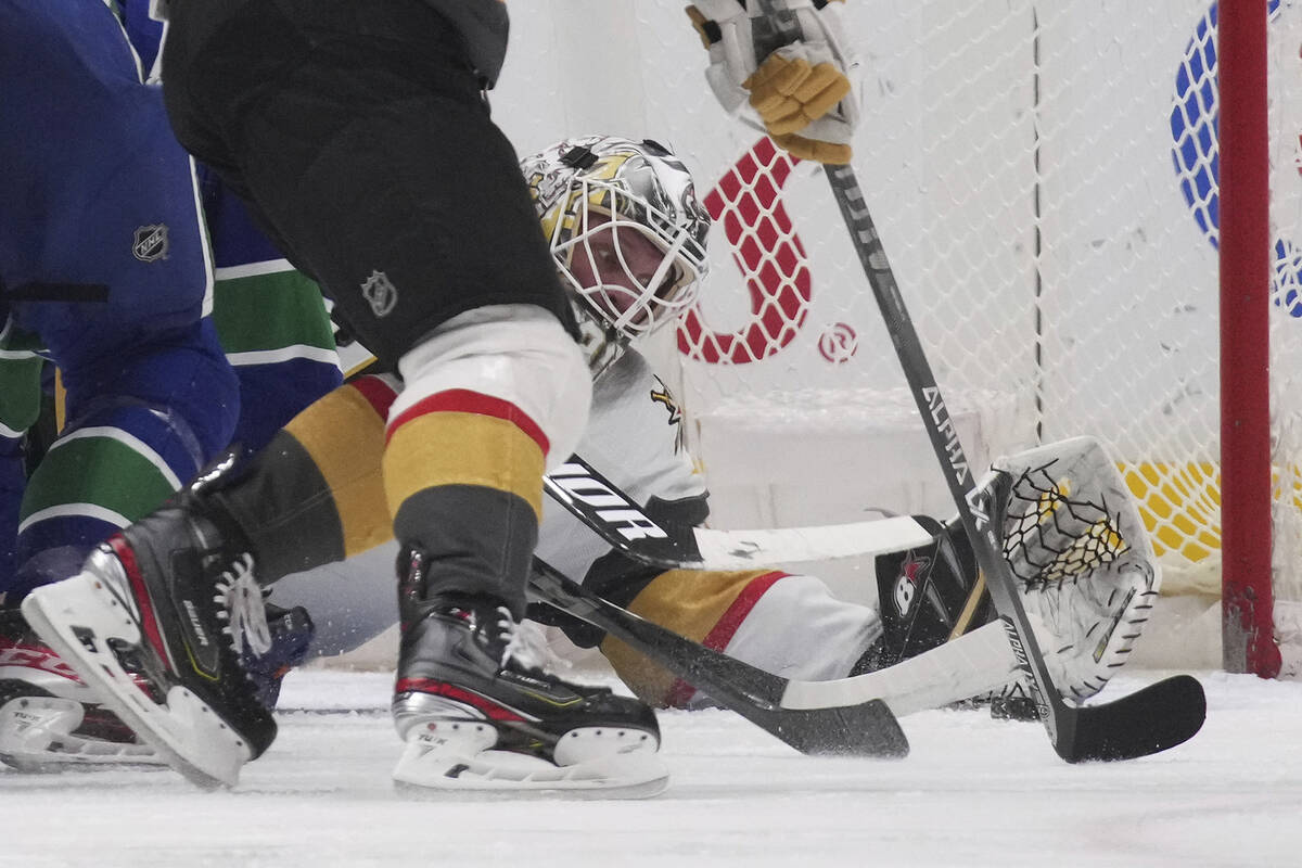 Vegas Golden Knights goalie Robin Lehner reaches to make the glove save against the Vancouver C ...