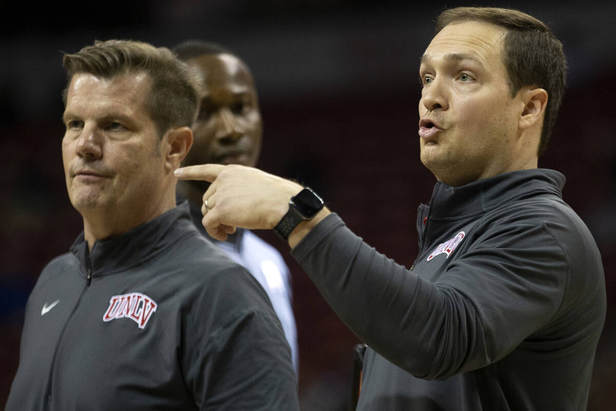 UNLV Rebels head coach Kevin Kruger, right, and assistant coach Tim Buckley guide the team duri ...