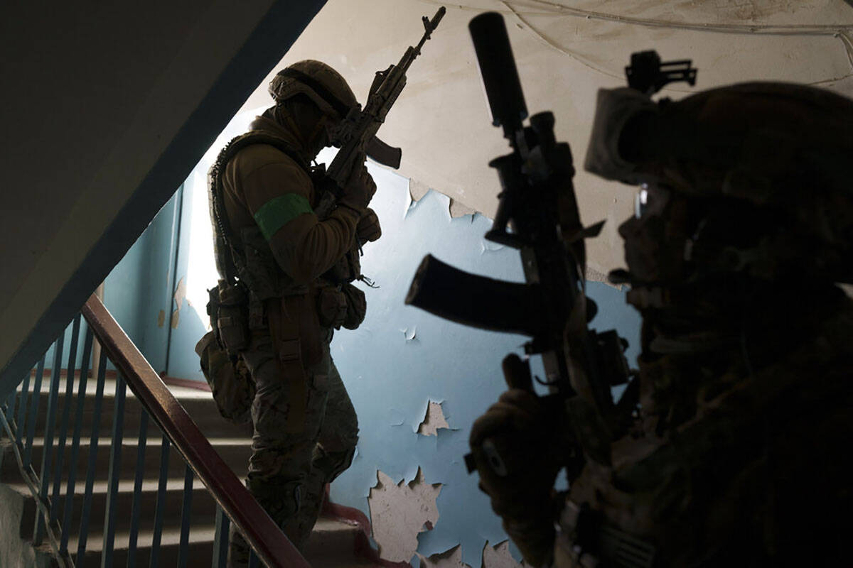 Security Service of Ukraine (SBU) servicemen enter a building during an operation to arrest sus ...