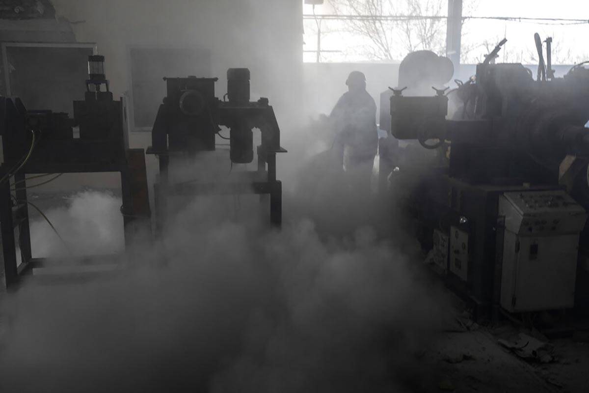 Firefighters try to extinguish the fire at a damaged factory following a Russian bombing in Kra ...