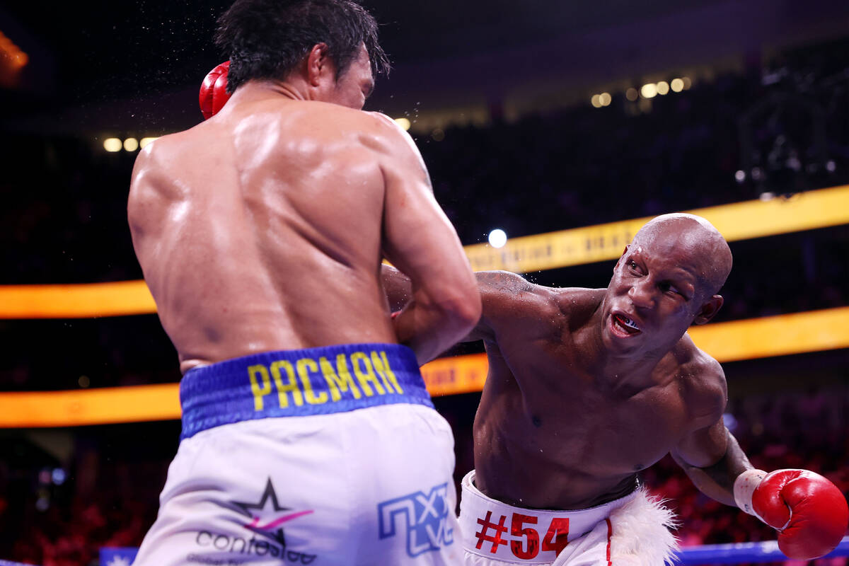 Yordenis Ugas, right, connects a punch against Manny Pacquiao in the ninth round of the WBA Wor ...