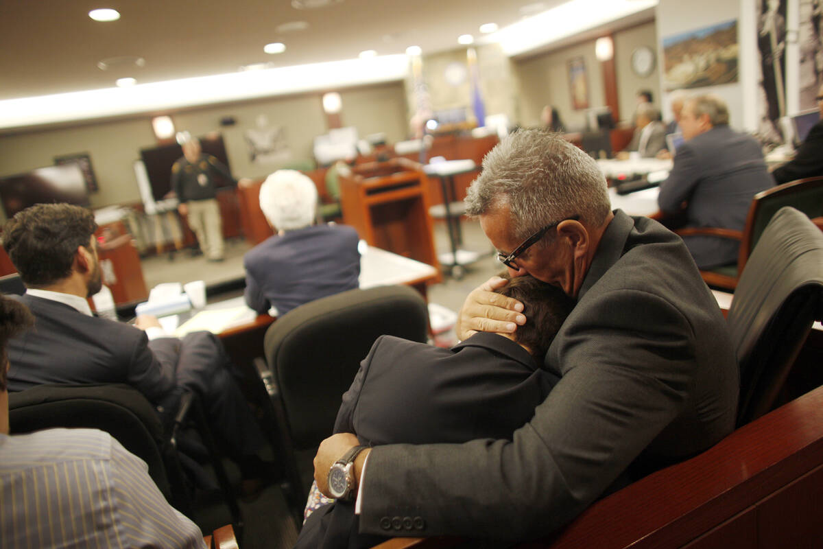 FILE - Gavin Cox holds his wife Minh-Hahn Cox as they wait for the jury's decision in his trial ...