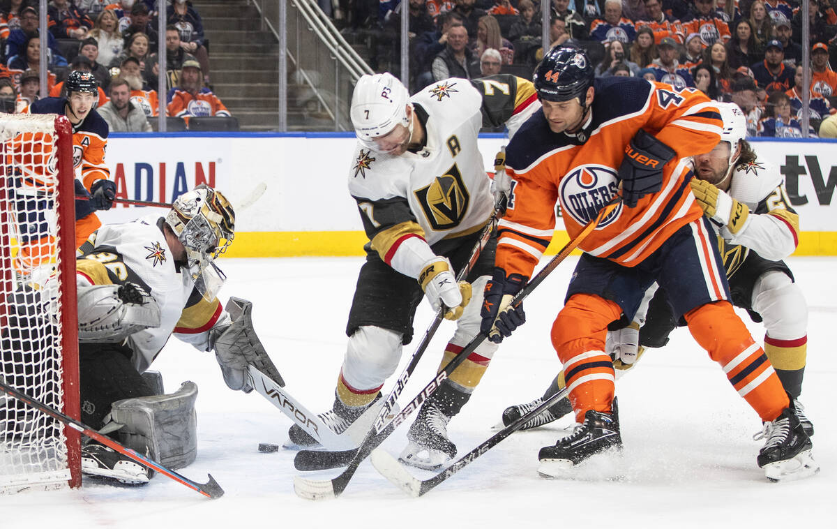 Vegas Golden Knights goalie Logan Thompson (36) makes the save as Edmonton Oilers' Zack Kassian ...