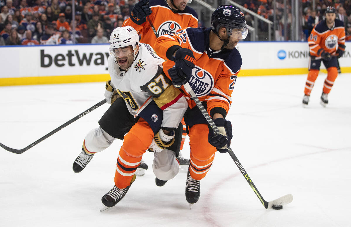 Vegas Golden Knights' Max Pacioretty (67) and Edmonton Oilers' Darnell Nurse (25) battle for th ...