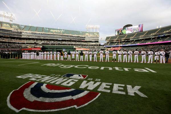 The Oakland Athletics line up on the baseline before a baseball game against the Baltimore Orio ...