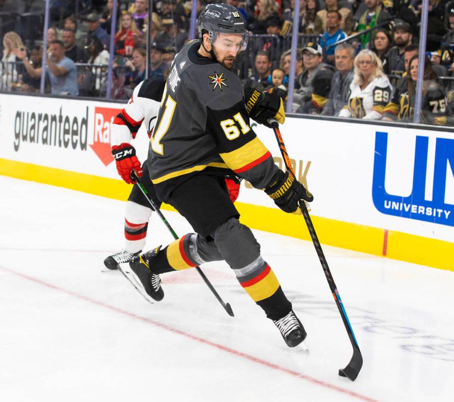 Golden Knights right wing Mark Stone (61) pushes the puck up ice in the first period during an ...