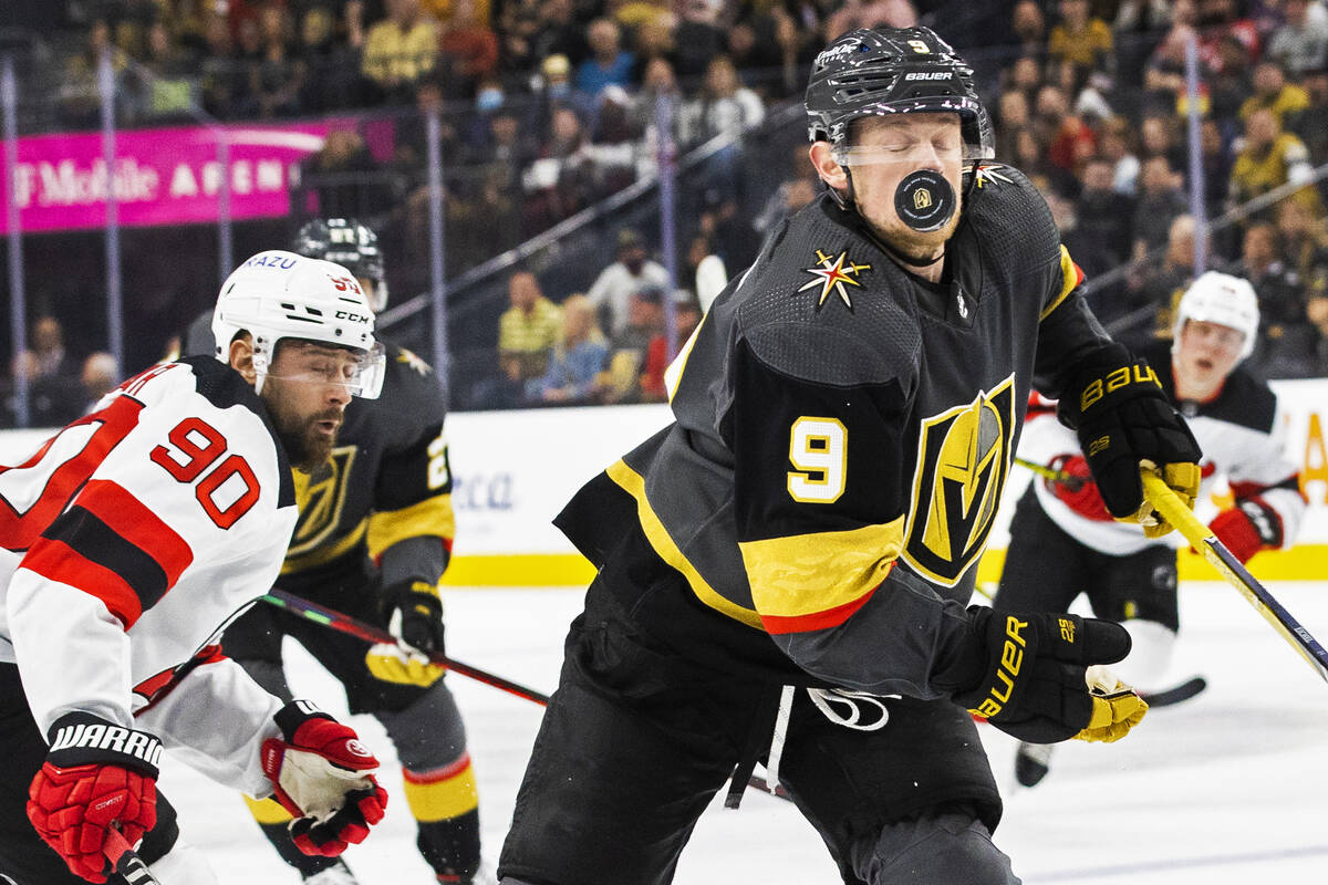 Golden Knights center Jack Eichel (9) takes a puck off the face with New Jersey Devils left win ...