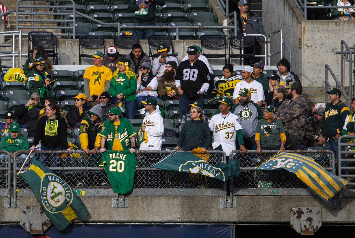 Oakland Athletics fans stand for the national anthem before the opening night game against the ...