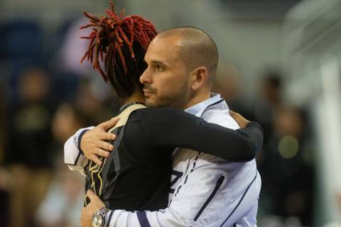 Spring Valley High School coach Billy Hemberger hugs senior Aaliyah Gayles following their loss ...