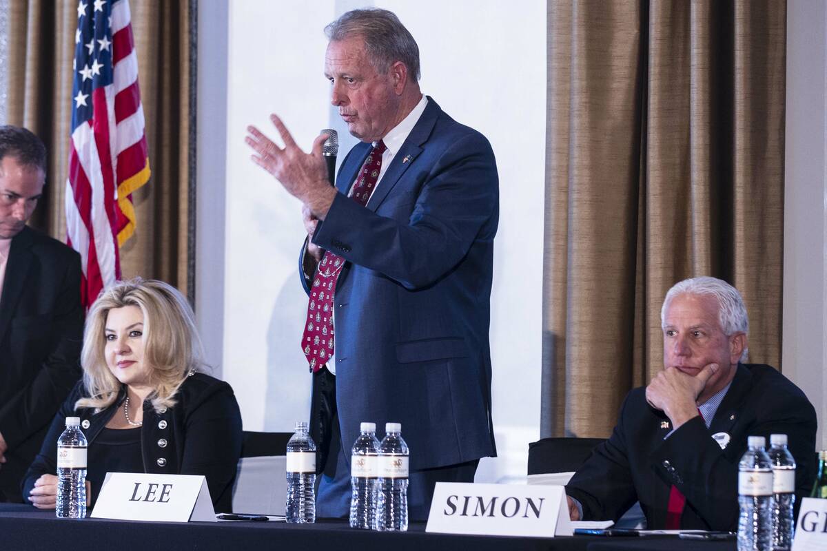 Nevada Republican governor candidates Michele Fiore, left, and Fred Simon, listen as North Las ...