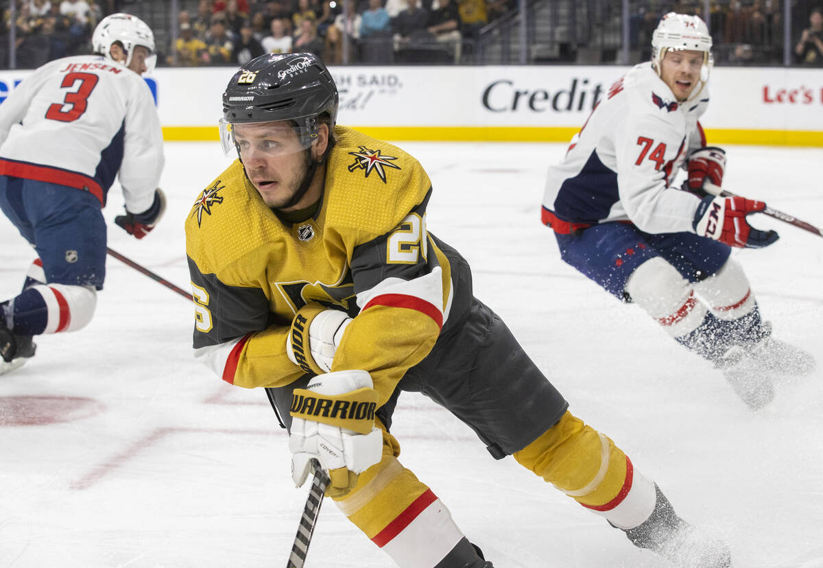 Golden Knights center Mattias Janmark (26) pushes the puck up ice with Washington Capitals defe ...