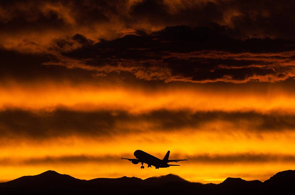 A Virgin America flight departs from McCarran International Airport as shown from the runway vi ...