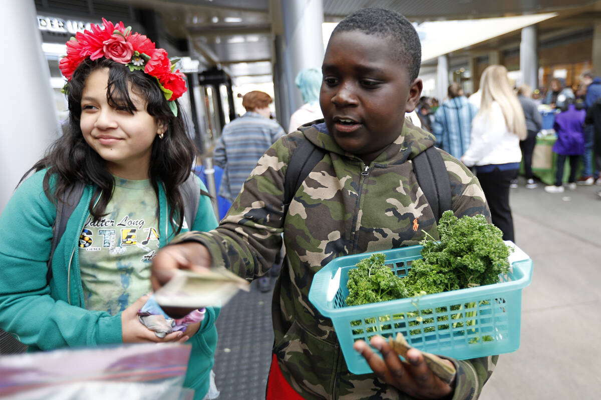 Long Elementary School students Gթonte Brady, 11 and Maria Quintanilla, 11, sell vegetables, F ...