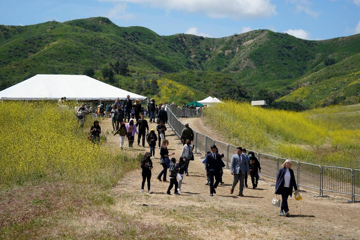 Attendees walk on a hiking path during a ground breaking ceremony for the Wallis Annenberg Wild ...