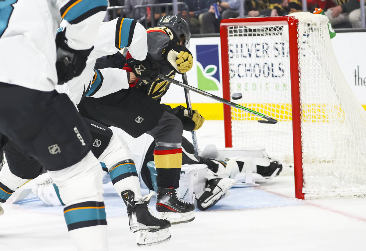 Golden Knights center Chandler Stephenson (20) scores a goal past San Jose Sharks goaltender Ja ...