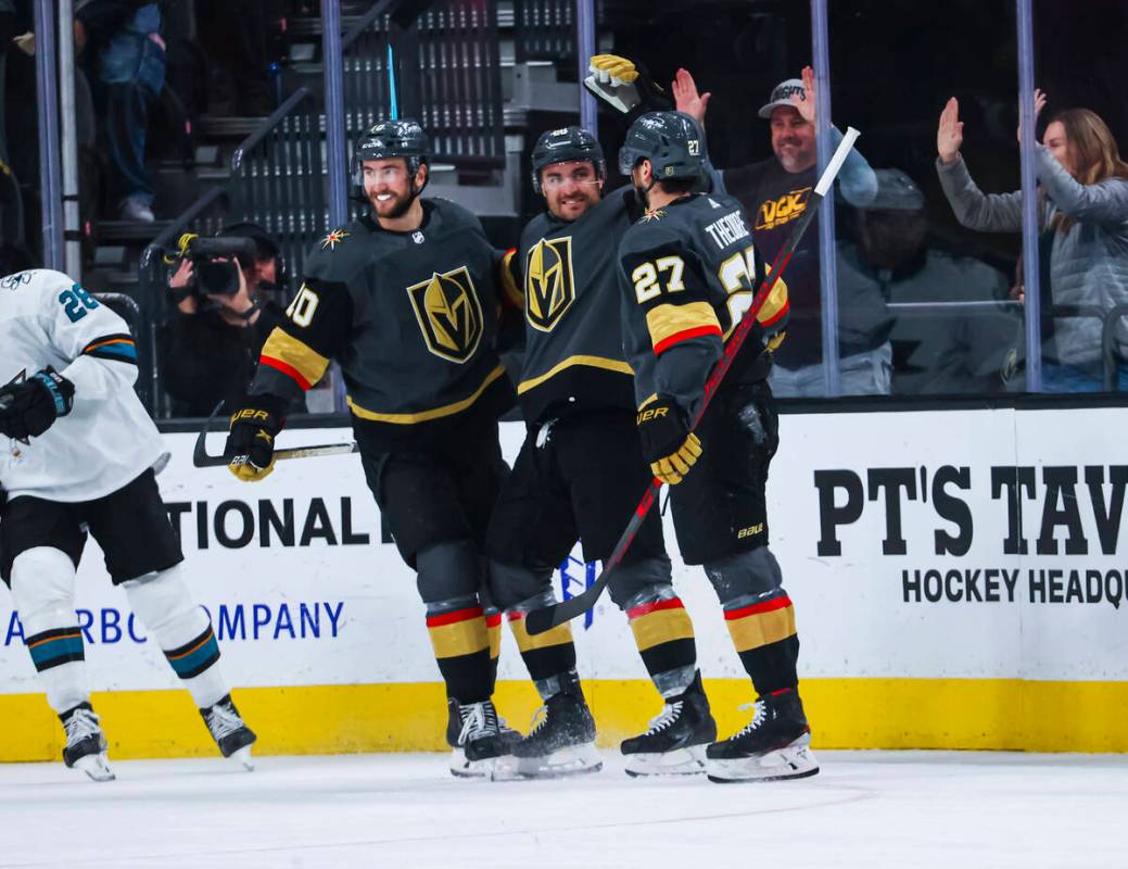 Golden Knights left wing William Carrier, center, reacts alongside center Nicolas Roy (10) and ...