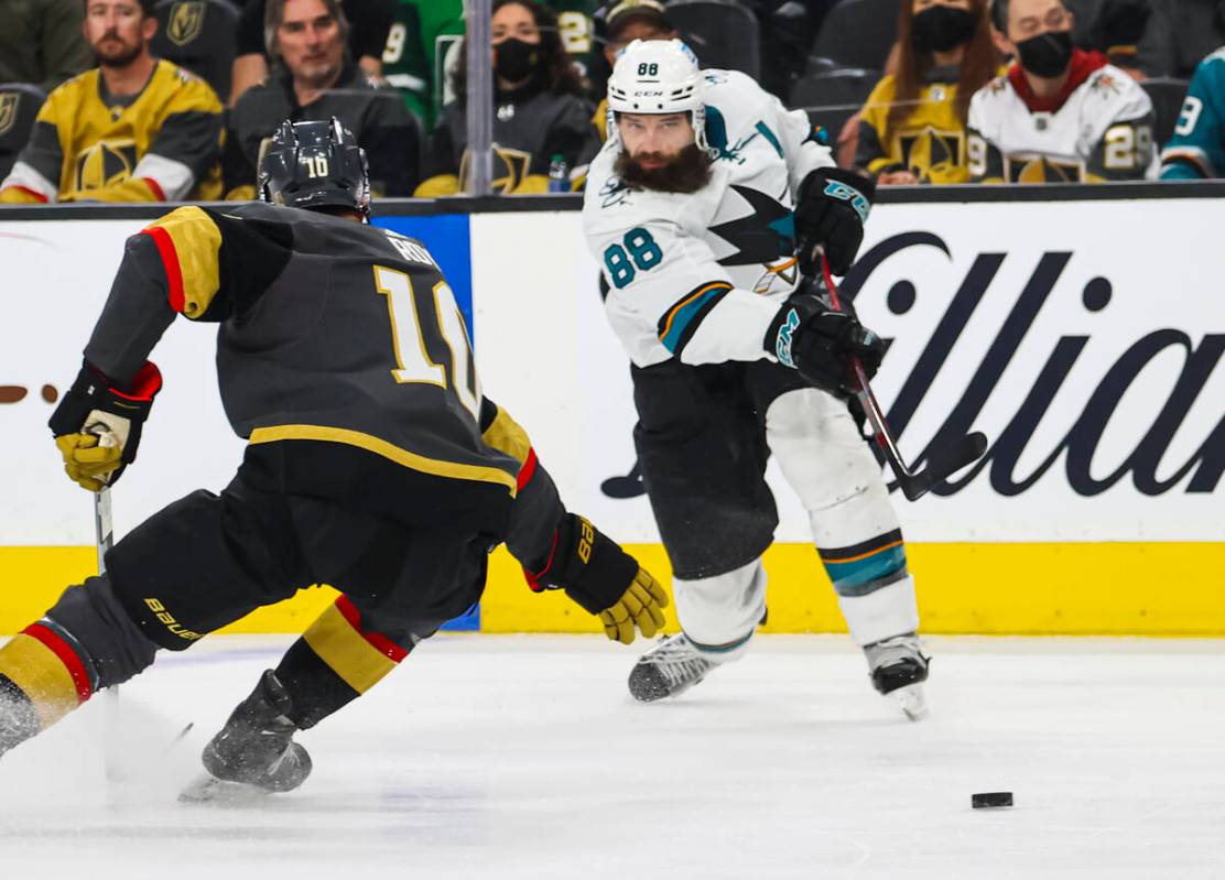 San Jose Sharks defenseman Brent Burns (88) shoots past Golden Knights center Nicolas Roy (10) ...