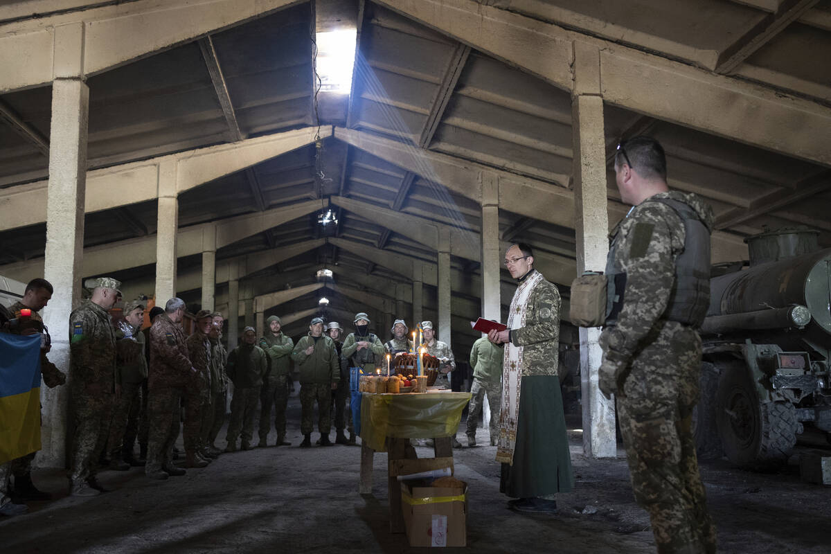 A military Orthodox priest leads a service during the Easter celebration at the frontline posit ...