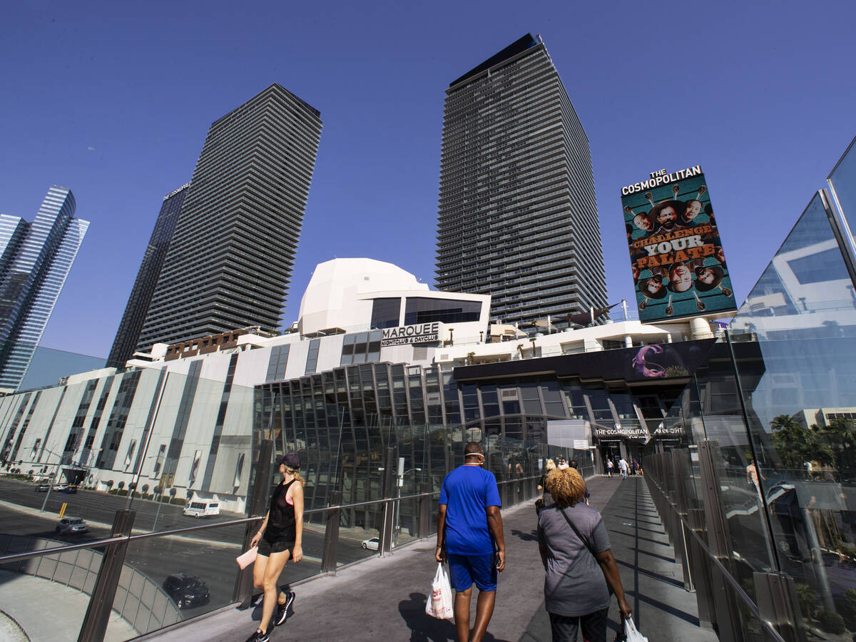 Pedestrians walk on pedestrian bridge near the Cosmopolitan of Las Vegas, on Monday, Sep. 27, 2 ...