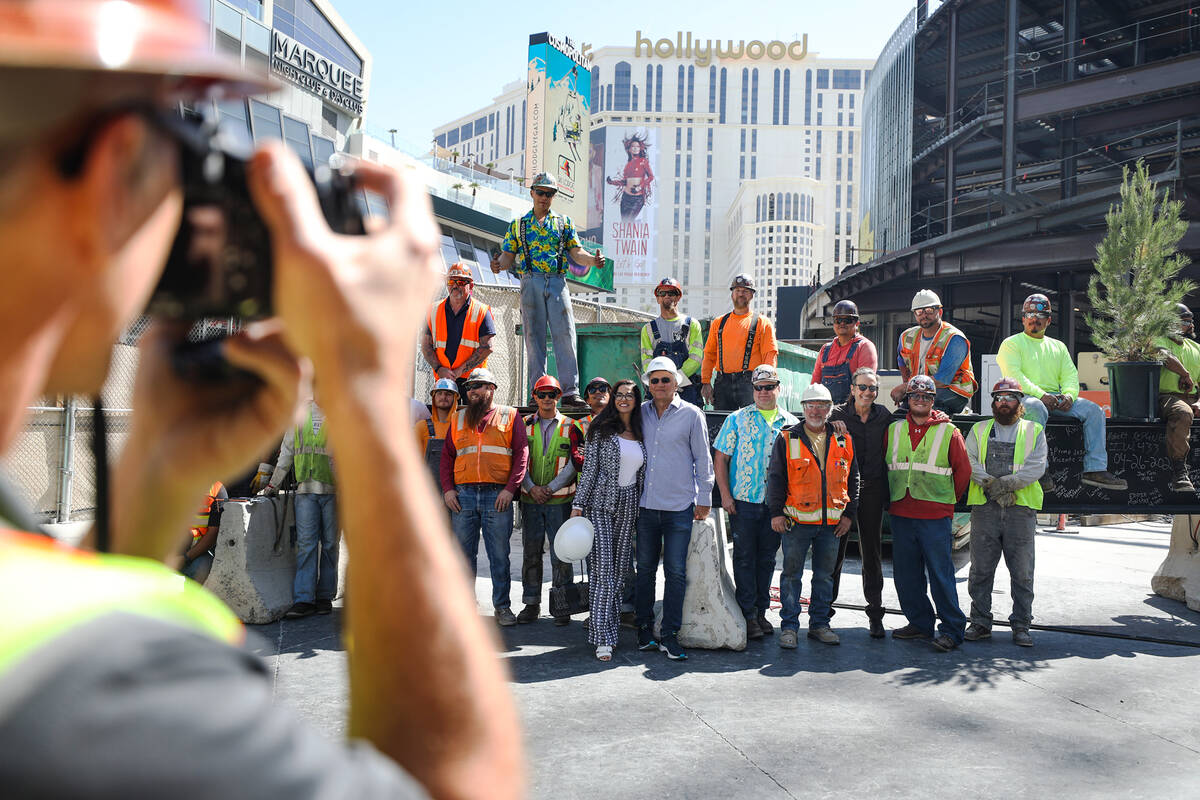 Developer partners Dayssi Kanavos and her husband Paul Kanavos, center, pose for a photo with w ...