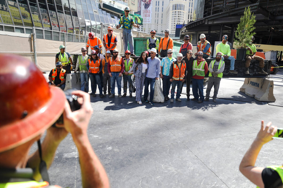 Developer partners Dayssi Kanavos and her husband Paul Kanavos, center, pose for a photo with w ...