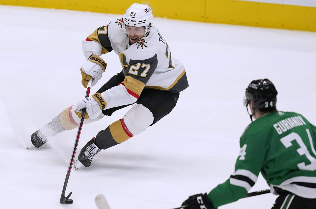 Vegas Golden Knights defenseman Shea Theodore (27) takes control of the puck in front of Dallas ...