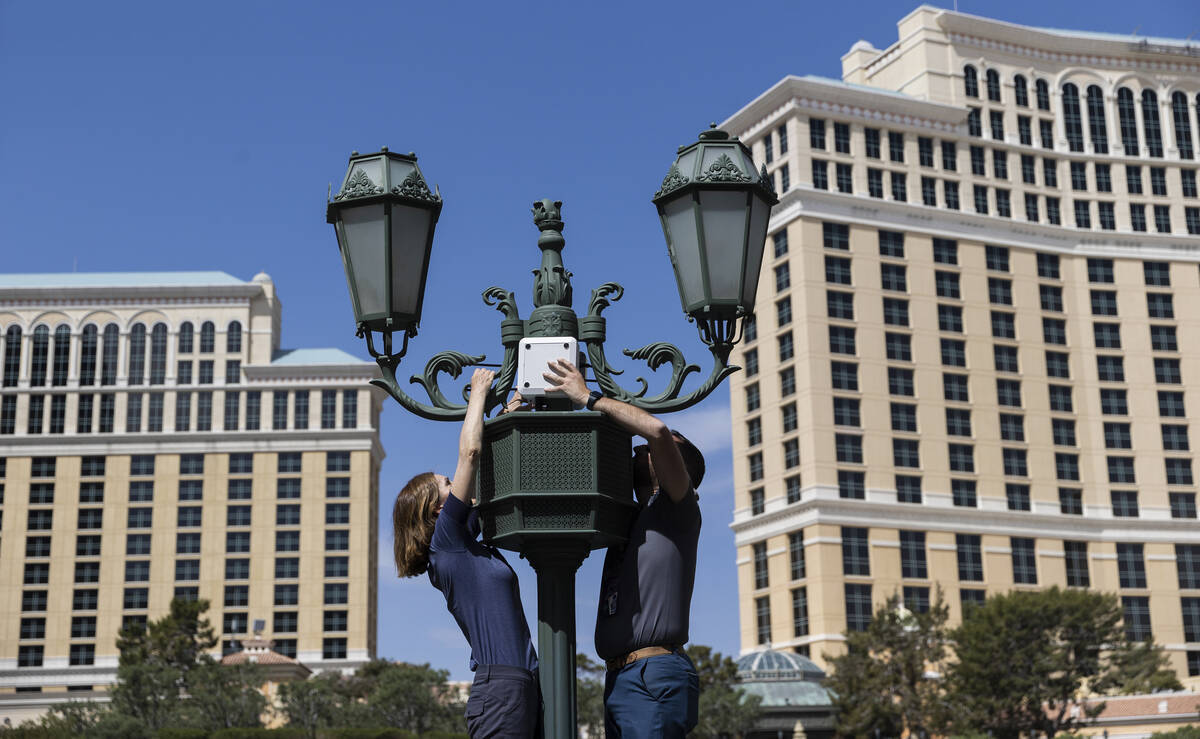 Workers install enhanced security measures near the NFL Draft Red Carpet Stage at the Bellagio ...
