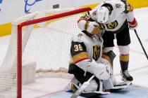 Vegas Golden Knights defenseman Dylan Coghlan (52) comforts goaltender Logan Thompson (36), who ...