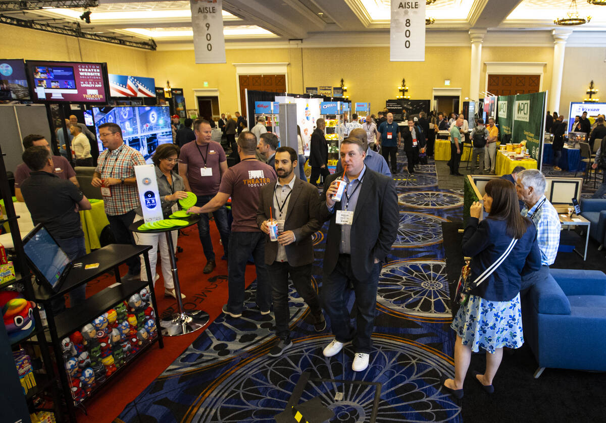 People walk the show floor at the CinemaCon trade show at Caesars Palace on Tuesday, April 26, ...