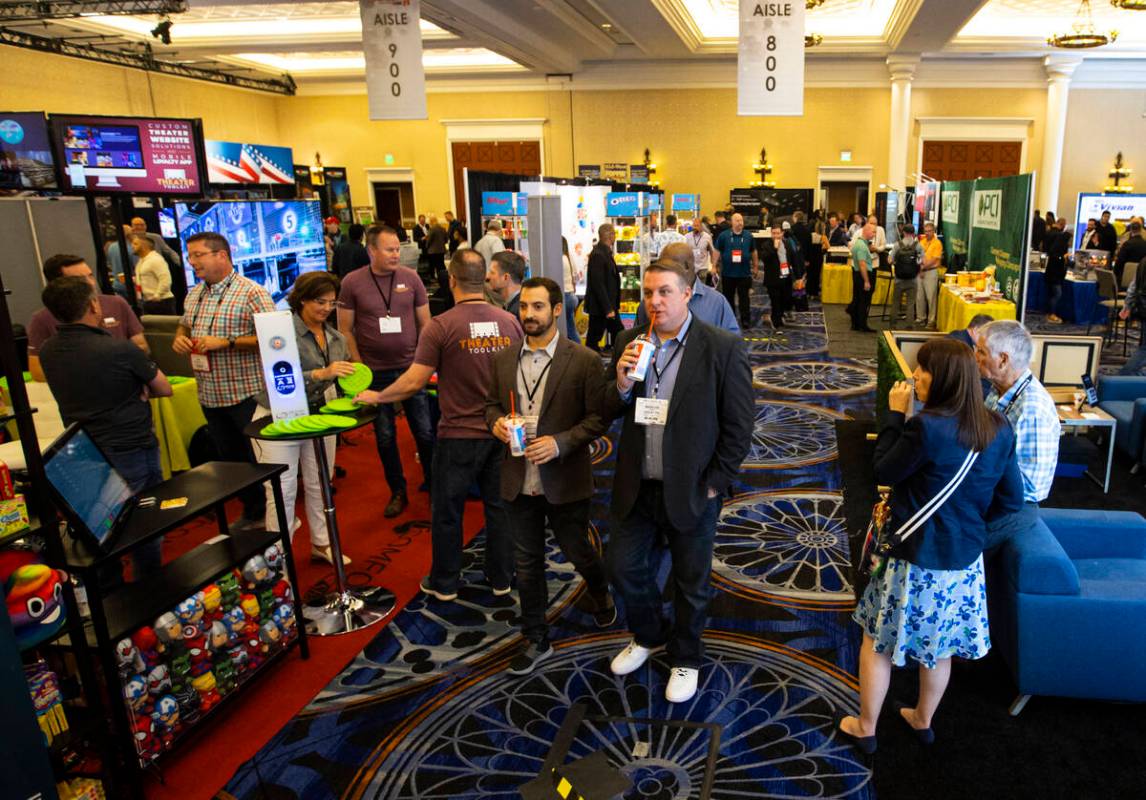 People walk the show floor at the CinemaCon trade show at Caesars Palace on Tuesday, April 26, ...