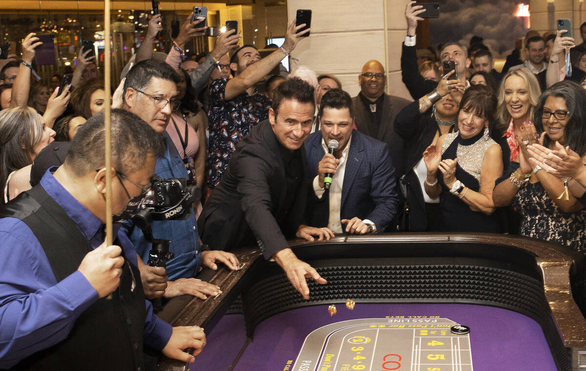 Dino DiCienzo, left, throws the ceremonial first role during the reopening ceremony of the Palm ...