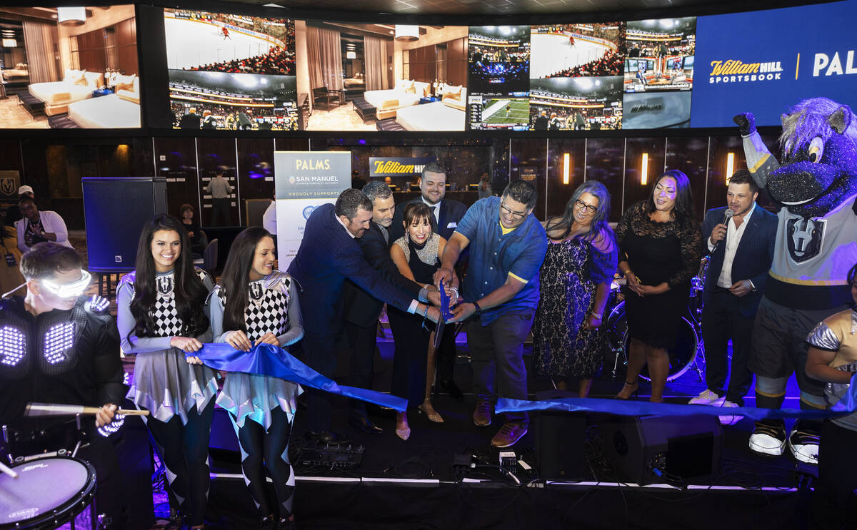 Palms general manager Cynthia Kiser Murphy, middle, gets help cutting the ribbon at William Hil ...