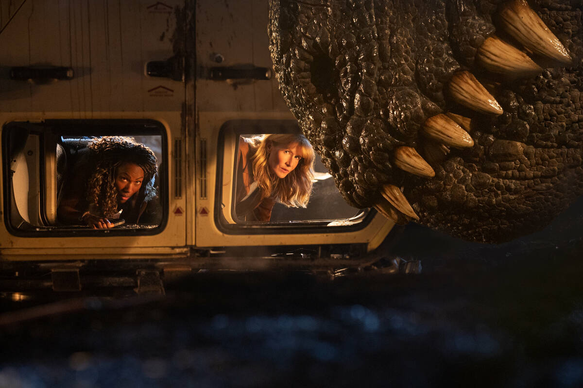 Kayla Watts (DeWanda Wise), left, Dr. Ellie Sattler (Laura Dern) and a giganotosaurus in "Juras ...