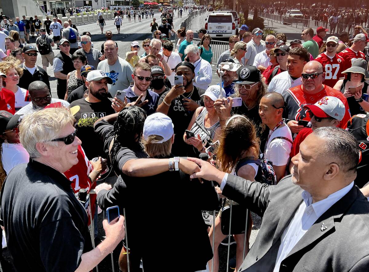 Las Vegas Raiders owner Mark Davis, center, takes a photo with fans, Thursday, April 28, 2022, ...
