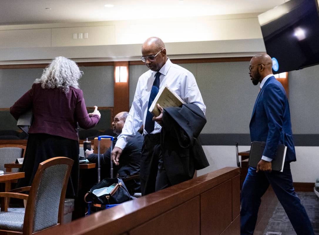 Wendell Melton, center, accused of killing his 14-year-old son in 2017, arrives in court with h ...