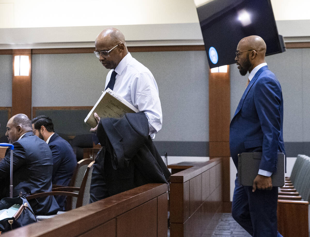 Wendell Melton, left, accused of killing his 14-year-old son in 2017, arrives in court with his ...