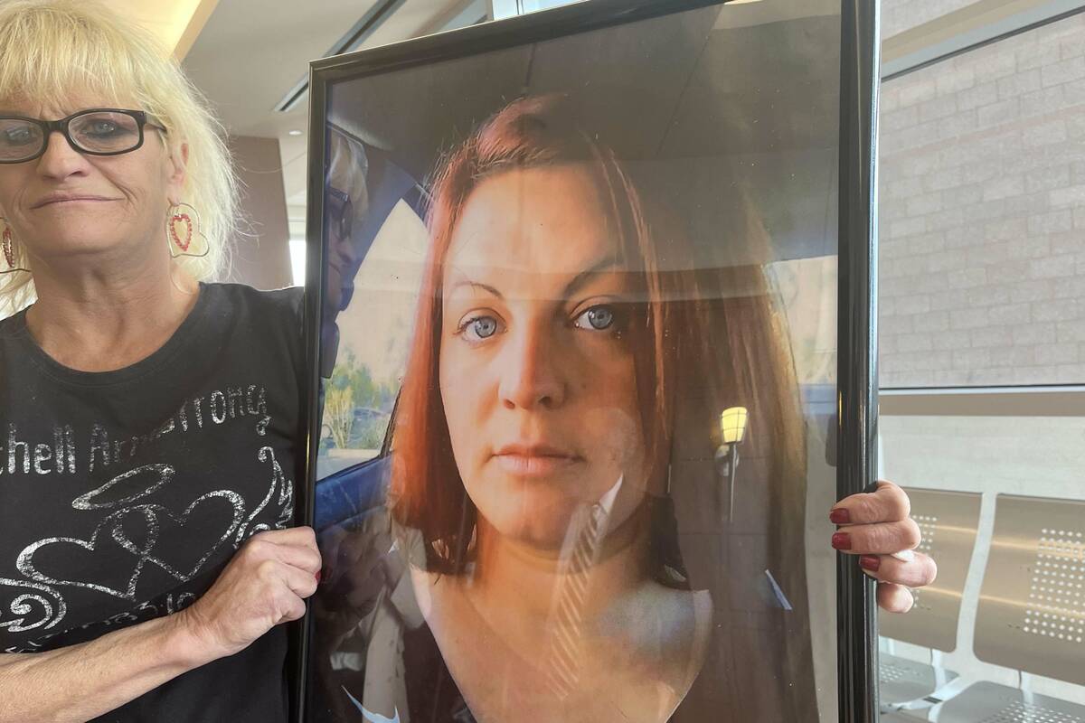 Cherylene Price stands with a picture of her daughter, Michell Armstrong, following a sentencin ...