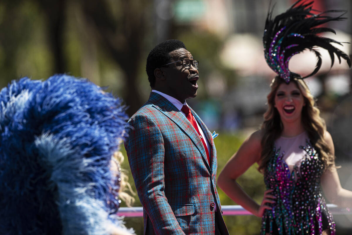 Cowboy legend and NFL Network analyst Michael Irvin, middle, shares a laugh with showgirls at t ...