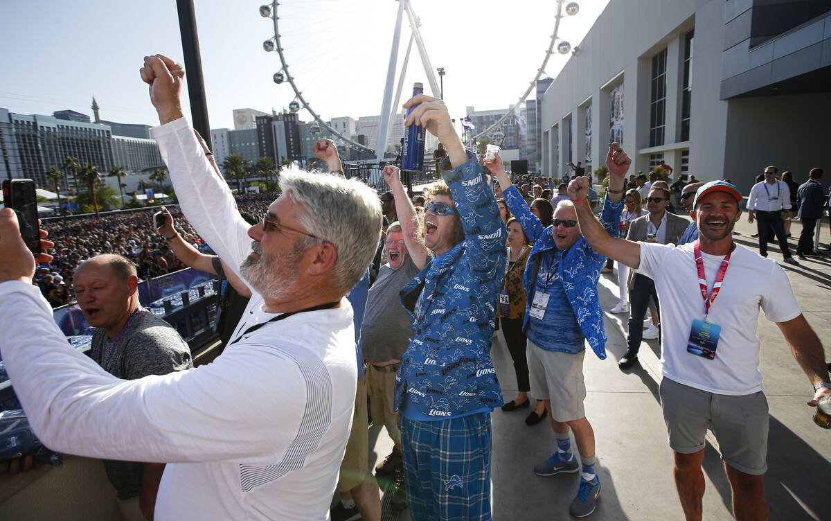 Detroit Lions fans, including Dustin Martini, of Los Angeles, center, celebrate as Aidan Hutchi ...