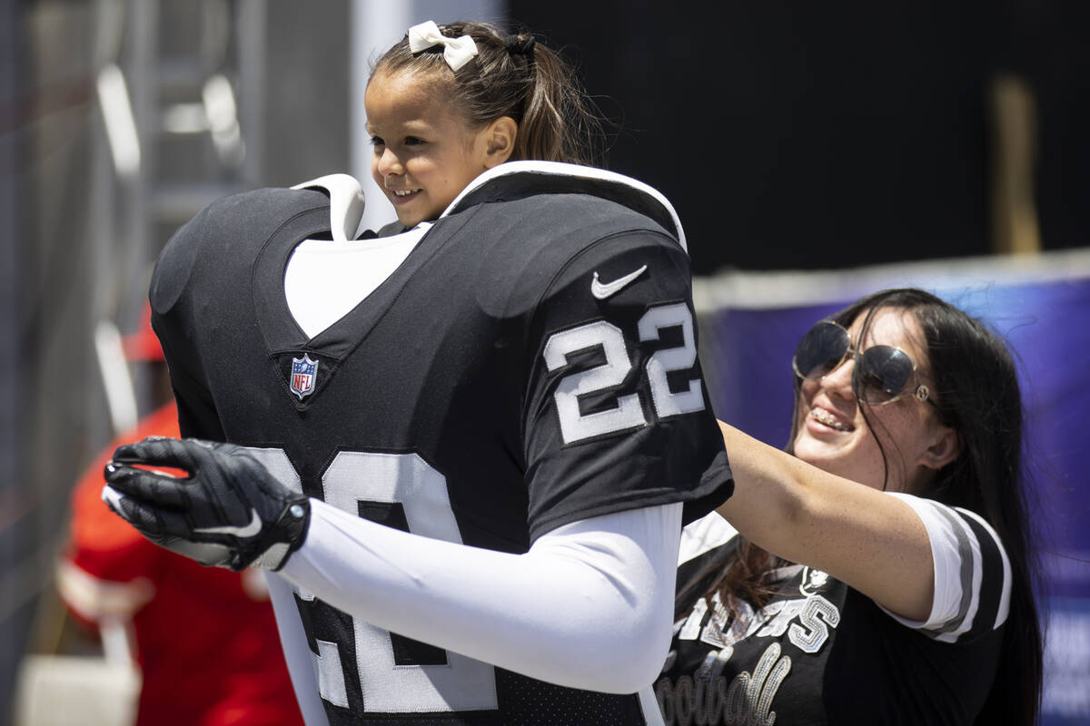 Lexi Gonzalez, 17, of California holds up her sister Briella Carrillo, 3, for a photo during th ...