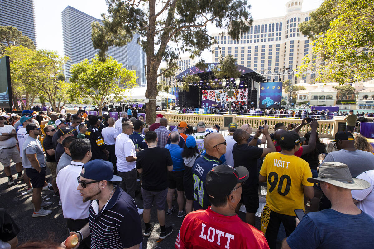 Crowds take in the sight of the red carpet stage at the Bellagio Fountains during the first day ...