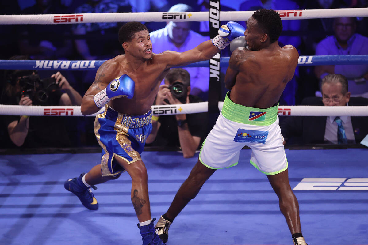 Shakur Stevenson, left, throws a punch against Jeremiah Nakathila, in the fifth round of the WB ...