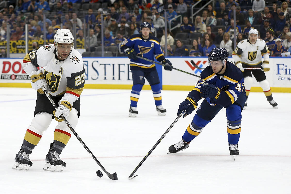 Vegas Golden Knights' Alec Martinez (23) controls the puck while under pressure from St. Louis ...