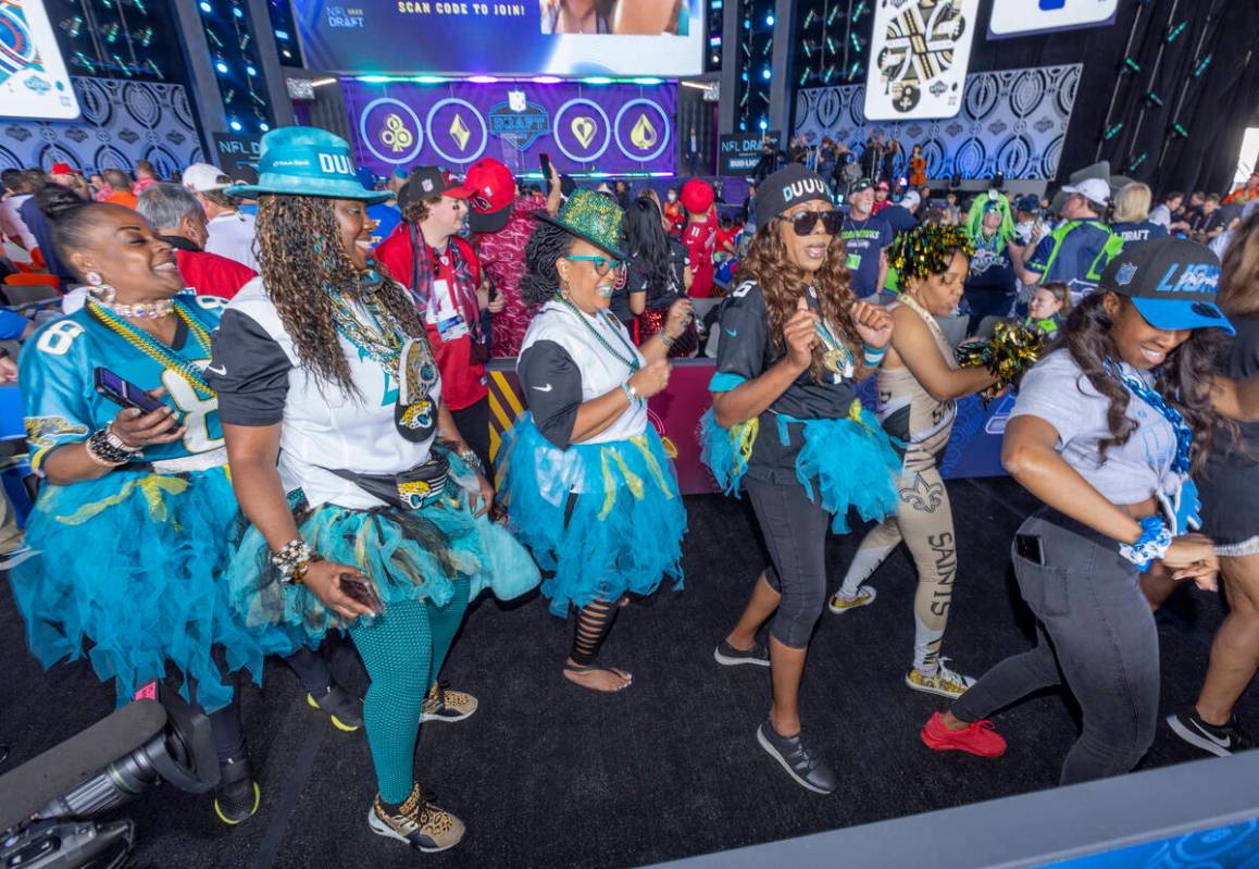 Fans dance together in the Draft Theater during the second day selections for the 2022 NFL draf ...